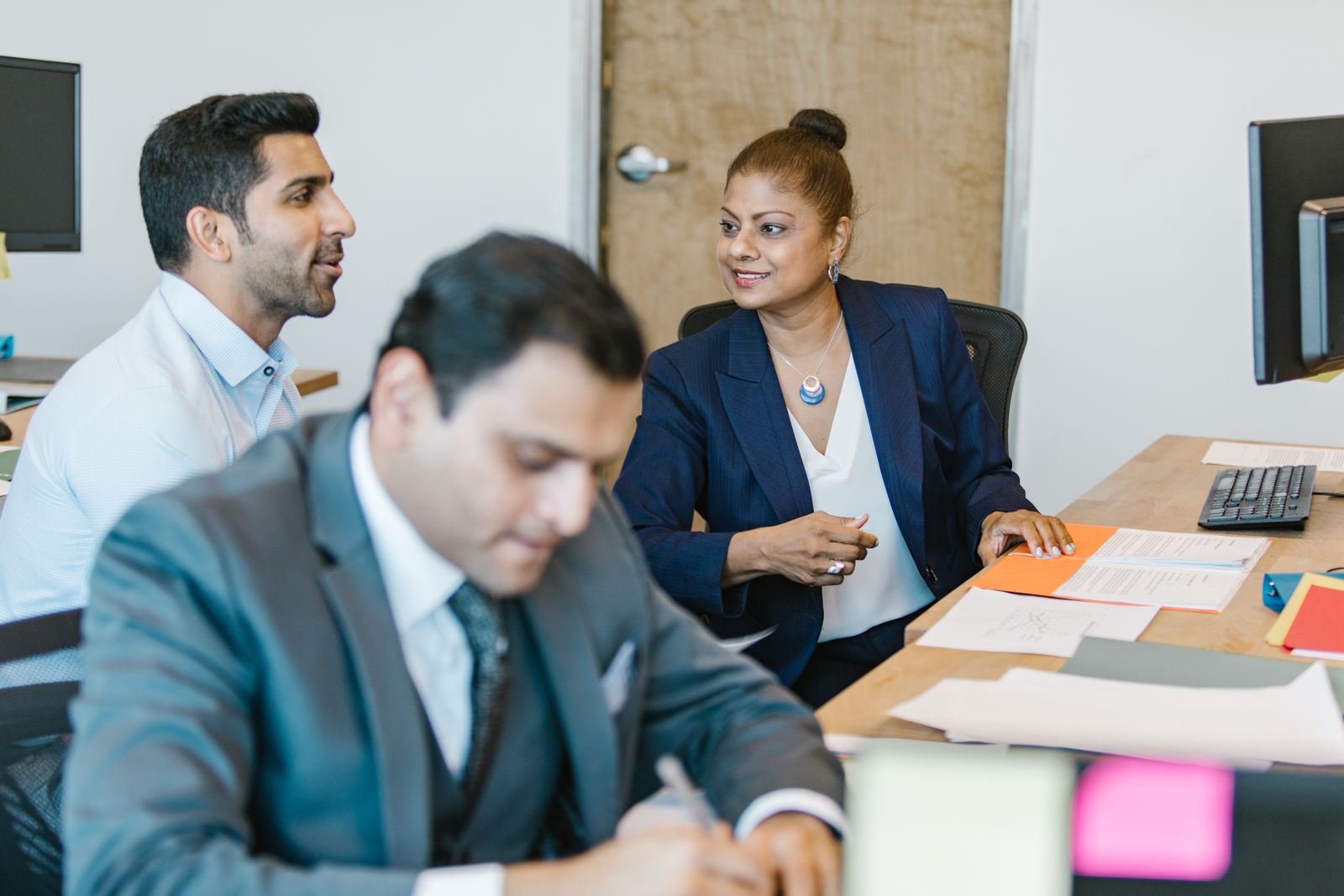 Pest control business owners meeting around a table
